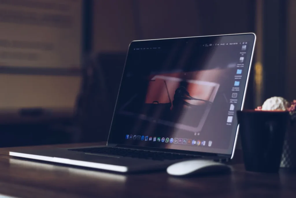 Open silver laptop on a wooden desk